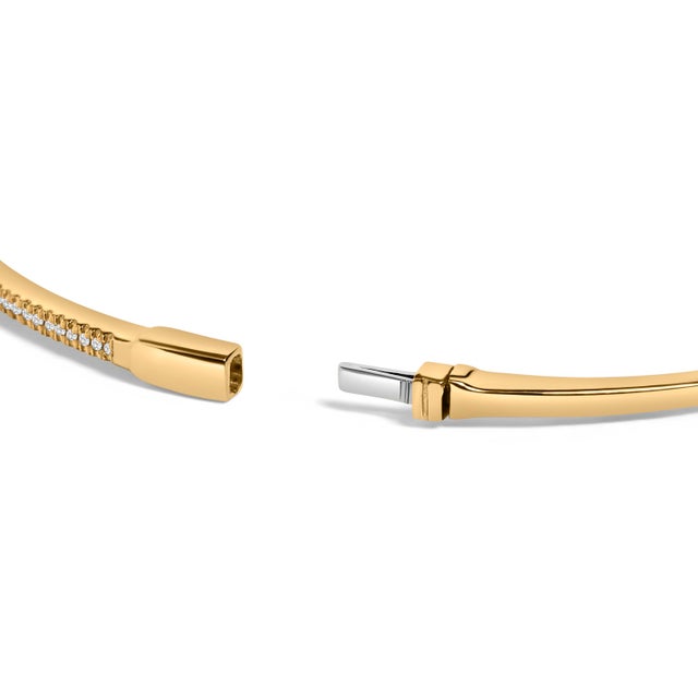Immerse yourself in the delicate luxury of this 14K yellow gold bangle bracelet, where traditional elegance meets refined...