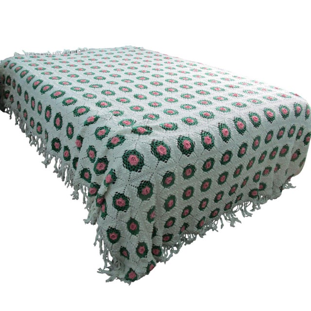 This handmade crochet blanket features a granny square rose and pineapple or rose splendor design with intricate fringe...