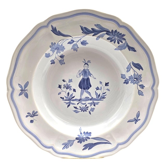 This rim soup bowl was produced by Longchamp in France as part of the Moustiers Blue series, a mid-century interpretation...