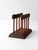 Mid-century wood holder with sculpted rails, turned dowel supports, and a rich walnut-toned finish. A warm, functional...