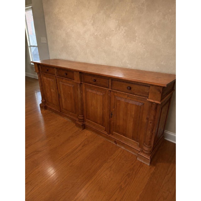 Beautiful antique pine credenza/buffet. This very large piece features four drawers with spacious cabinets beneath for...