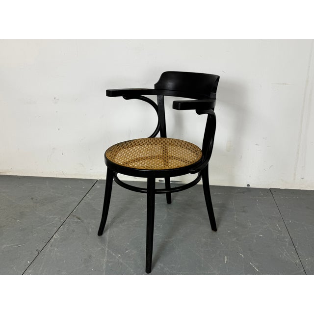 Black Thonet mod 233 bentwood desk chair with handwoven rattan seat, 1920s This piece is attributed to the mentioned...