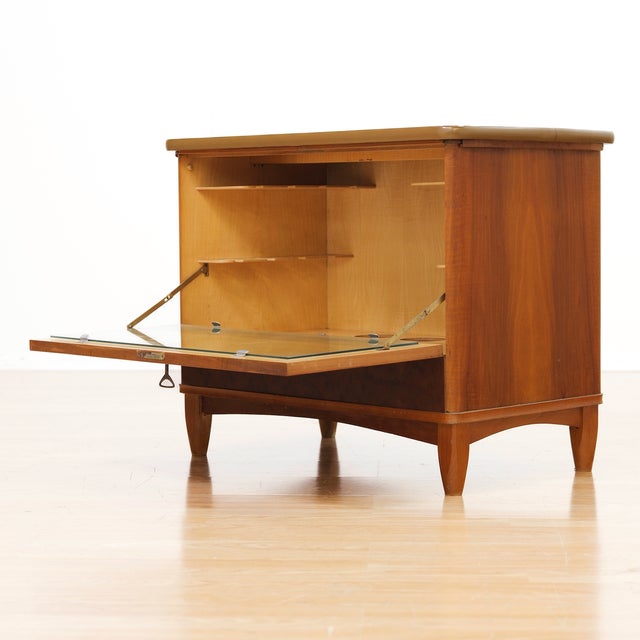 A beautifully engineered British liquor cabinet dating from the 1950s, featuring an ingenious mechanical opening action...