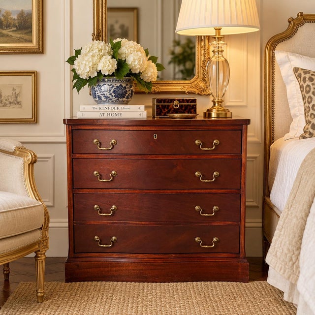 Elegant vintage mahogany three-drawer nightstand or bachelor’s chest featuring a graceful serpentine front and warm...