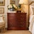 Elegant vintage mahogany three-drawer nightstand or bachelor’s chest featuring a graceful serpentine front and warm...