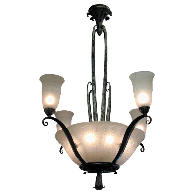 Elegant French Art Deco hand hammered iron and glass chandelier featuring four panels and four matching tulips. The...