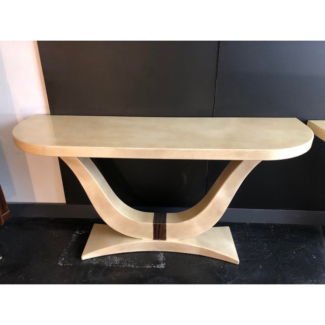 Solid wood console table covered in faux parchment, 1970s, in the style of Karl Springer. USA. Circa 1970. The legs are...
