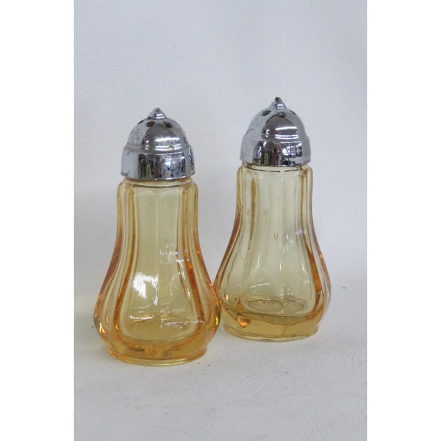 These beautiful vintage Salt and Pepper Shakers are made of pressed glass. Both Shakers in this lovely set present a...