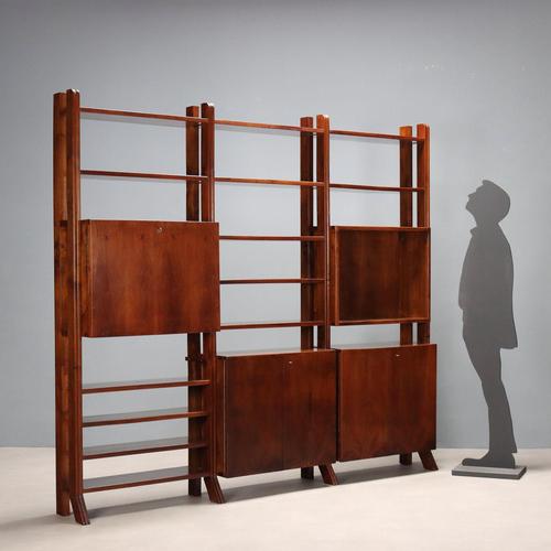 Freestanding vintage walnut bookcase with shelves, storage compartments with hinged doors and a drop-down compartment....