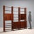 Freestanding vintage walnut bookcase with shelves, storage compartments with hinged doors and a drop-down compartment....