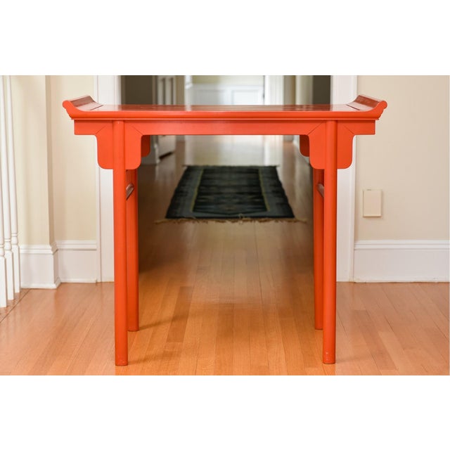 A Qing Dynasty style red lacquered altar form console table with simple straight pole legs and stretchers made using...