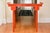 A Qing Dynasty style red lacquered altar form console table with simple straight pole legs and stretchers made using...