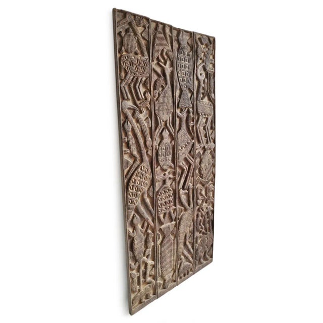 Vintage carved wood original Nupe grain door. Beautiful original piece displayed as wall art.