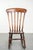 We are offering this antique English oak Windsor rocking chair from the early 19th century, featuring beautiful warm...