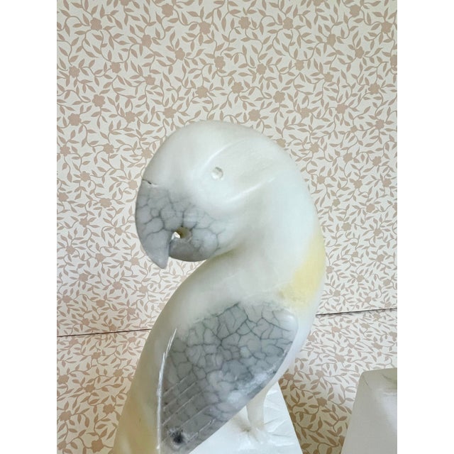 A graceful pair of Italian alabaster bookends featuring sculptural bird forms with softly carved details. The translucent...