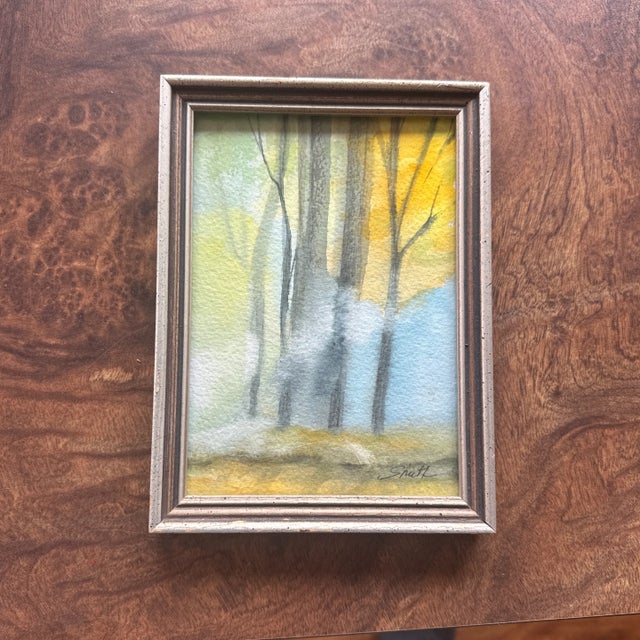 Soft washes of cool blue and warm yellow bring this peaceful forest scene to life. Light filters through tall, slender...