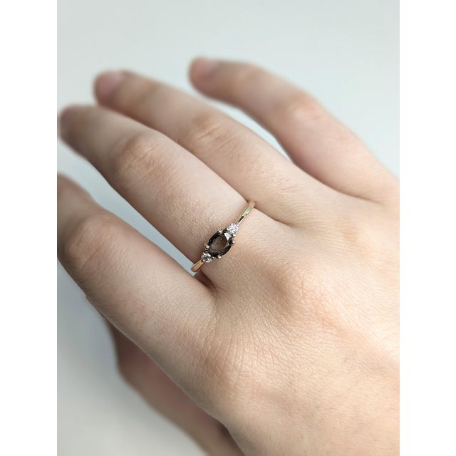 Perfect for a meaningful gift or engagement, this three-stone ring features a rare 0.46ct oval alexandrite between two...