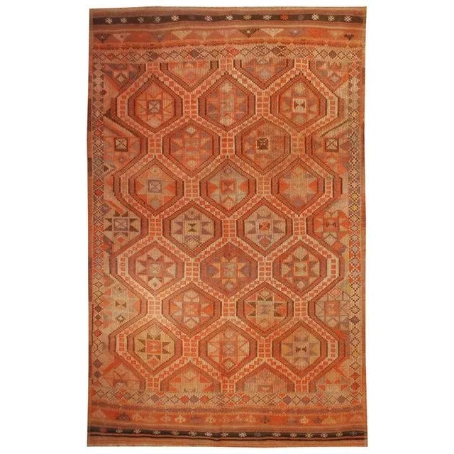 A mid-20th Century Turkish Verneh Kilim rug with an all-over eight-pointed star pattern with multiple complementary...