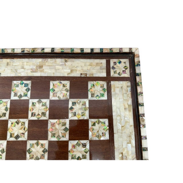 This handmade wooden chess board is crafted in a traditional antique style and beautifully decorated with genuine mother...