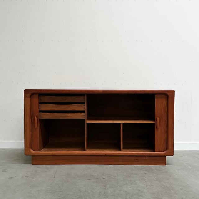 Danish Sideboard in Teak with Tambour Doors from Dyrlund, 1960s, in Very Good conditions. Designed 1960 to 1969 This piece...
