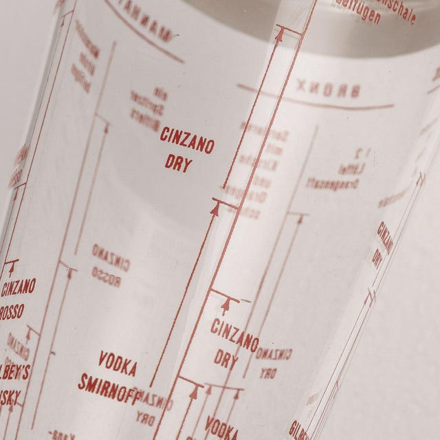 Antique mid-20th Century American recipe cocktail shaker, produced in the 1950's. The glass body describes how to make a...