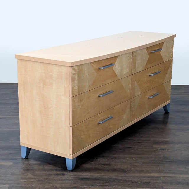 This Alf Italia dresser features a striking geometric wood pattern and six spacious drawers with sleek metal handles. The...