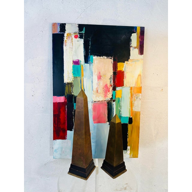 This is a pair of decorative obelisks with a classic, architectural presence. Here’s a detailed description: • Form &...