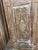 A striking blend of Old World craftsmanship and rustic-modern appeal, this antique carved door is a true statement piece...