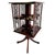 A Mahogany Revolving Bookcase, the figured mahogany top with satinwood banding, with Chippendale-style fretwork side...