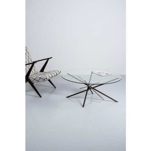 ‘Mikado’ coffee or side table made of a thick glass top with a metal frame in bronze, brass and red copper. In a good...