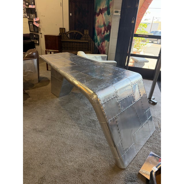 Striking aviator-style desk by Restoration Hardware, crafted in aluminum with a sculptural, aerodynamic silhouette. This...