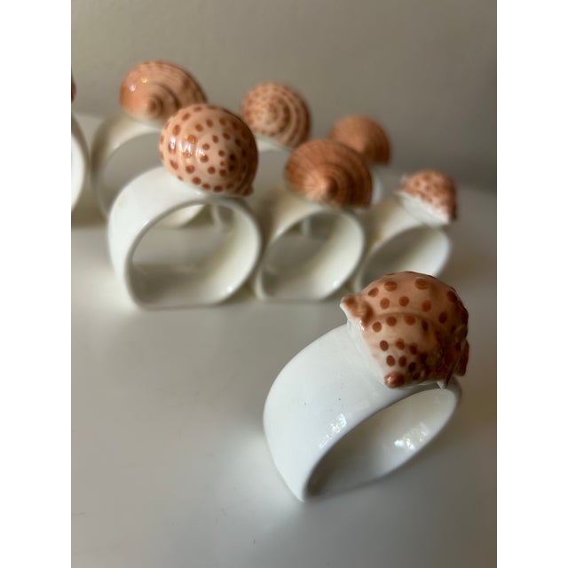 Fabulous set of vintage porcelain bone china napkin rings. Each white ring featuring a lovely seashell siting atop. By...