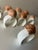 Fabulous set of vintage porcelain bone china napkin rings. Each white ring featuring a lovely seashell siting atop. By...