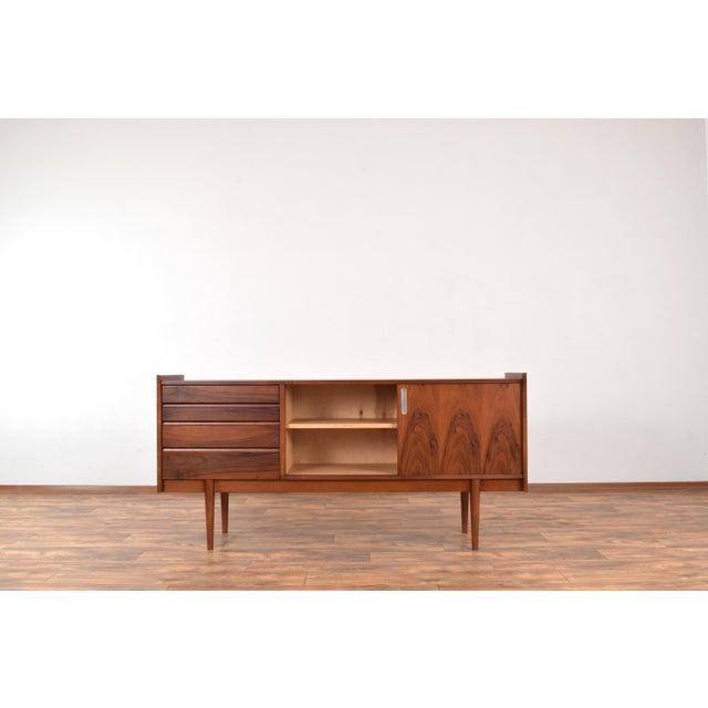 This sideboard was produced in Poland in the 1960s by Bytomskie Fabryki Mebli. The furniture is veneered with a beautiful...