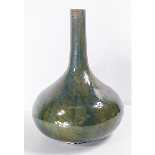 We are selling this pretty 19th century olive green and teal streaked vase. This vase is most likely German or Austrian...