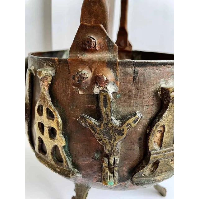 Vintage rustic, primitive folk art copper and brass three footed pot with handle. Old patina intact. Some oxidized copper.