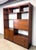 A beautiful mid century modern walnut wall unit featuring plenty of shelf space for books, vinyl records and objects, a...