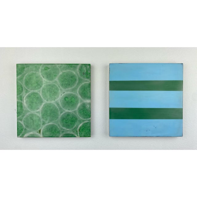 Two 8”x8” cradled wood panels. Each shape is hand cut from natural fiber papers and then suspended between layers of clear...