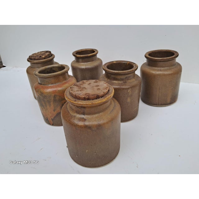 Set of six Armand Bizouard, early 1950s French stoneware mustard pots. Armand Bizouard came from a long line of mustard...