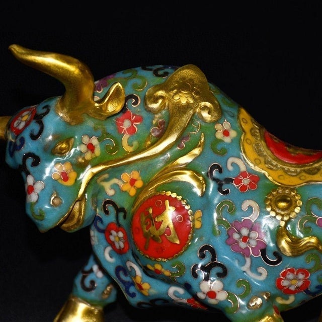 This striking vintage cloisonne enamel figurine depicts a powerful bull or ox, a traditional symbol of strength,...