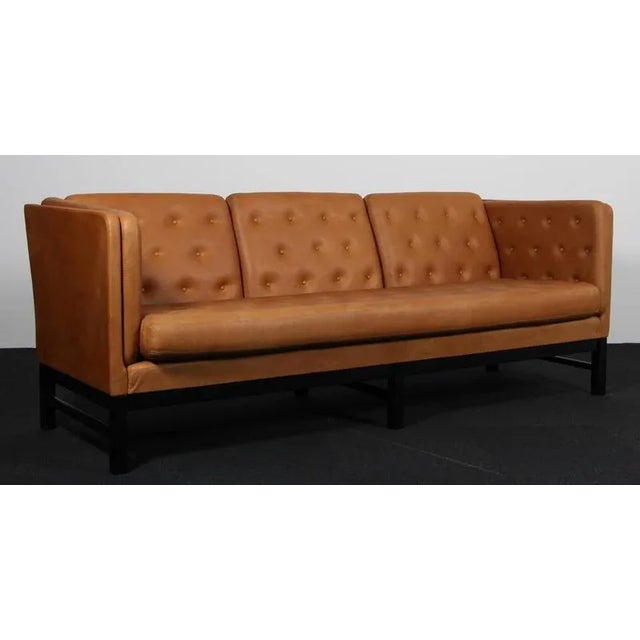 Erik Jørgensen three-seat new upholstered with cognac vintage full grain anilin leather. Frame of black lacquered beech....