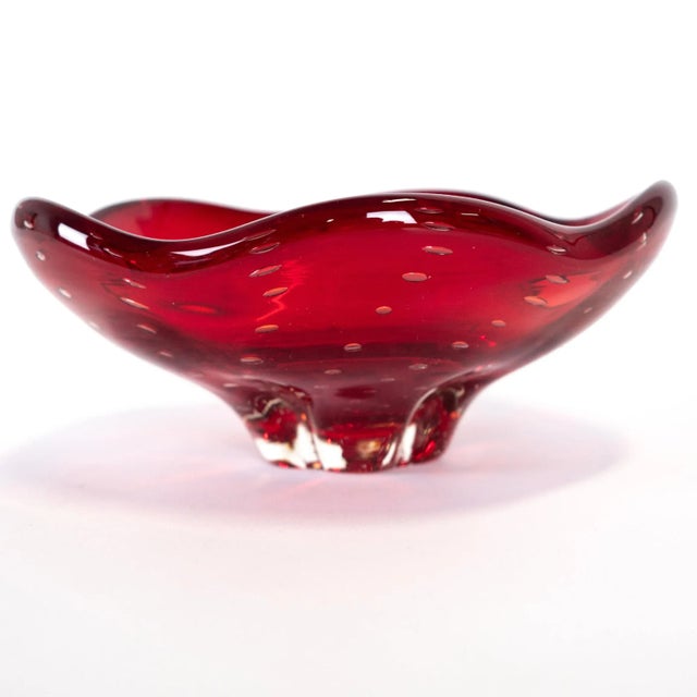 This red glass bowl is from Italy and features the bullicante bubble design. This piece was imported directly from Europe....