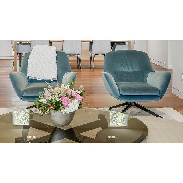 Pair of excellent condition, iconic Minotti Jensen swivel chairs available in incredibly soft aqua colored fabric...
