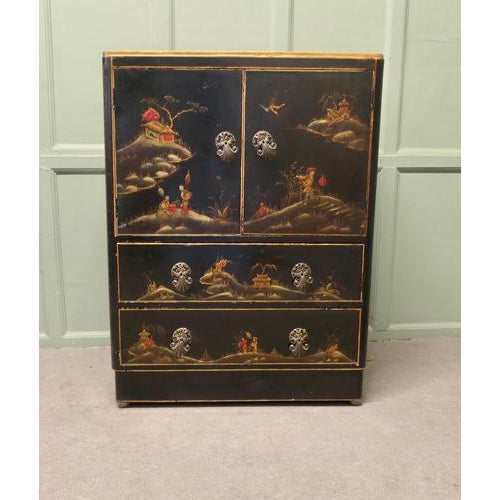 Colourful Early 20th Century Black Chinoiserie Lacquer Cupboard The cupboard is beautifully decorated with Chinese...