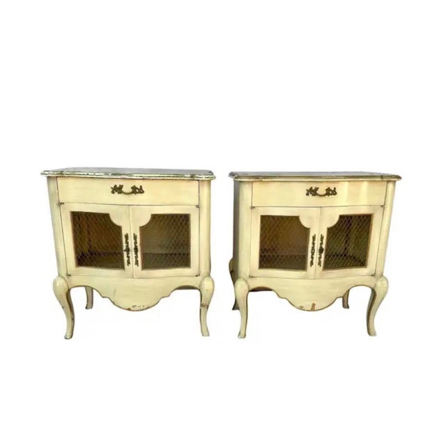 A Pair of Louis XV Style Nightstands by esteemed American maker John Widdicomb, celebrated for translating European...
