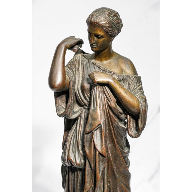 This exquisite bronze statue is a refined representation of the Diana of Gabii, depicting Artemis, the Greek goddess of...