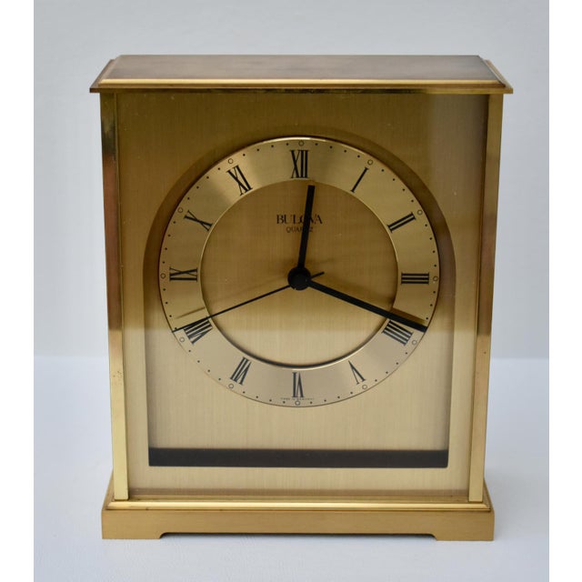 Vintage (1970's) Desk/Mantel Clock has a Contemporary Style. Made by Bulova. Brushed Brass Finish. Roman Numeral Display....