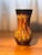 A 1970s ceramic vase by Saint-Clément, distinguished by its flared neck, pinched waist, and richly textured lava glaze in...