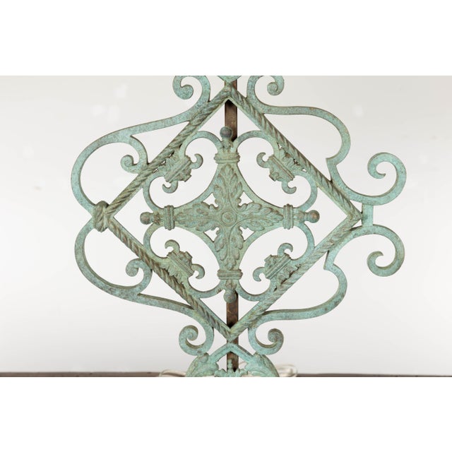 A pair of Italian Midcentury bronze table lamps with scrolling motifs, foliage, verdigris patina and custom made...