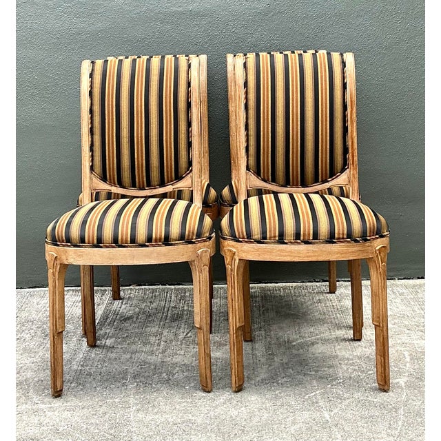 This sophisticated set of four vintage dining chairs seamlessly blends Art Deco geometric precision with Neoclassical...
